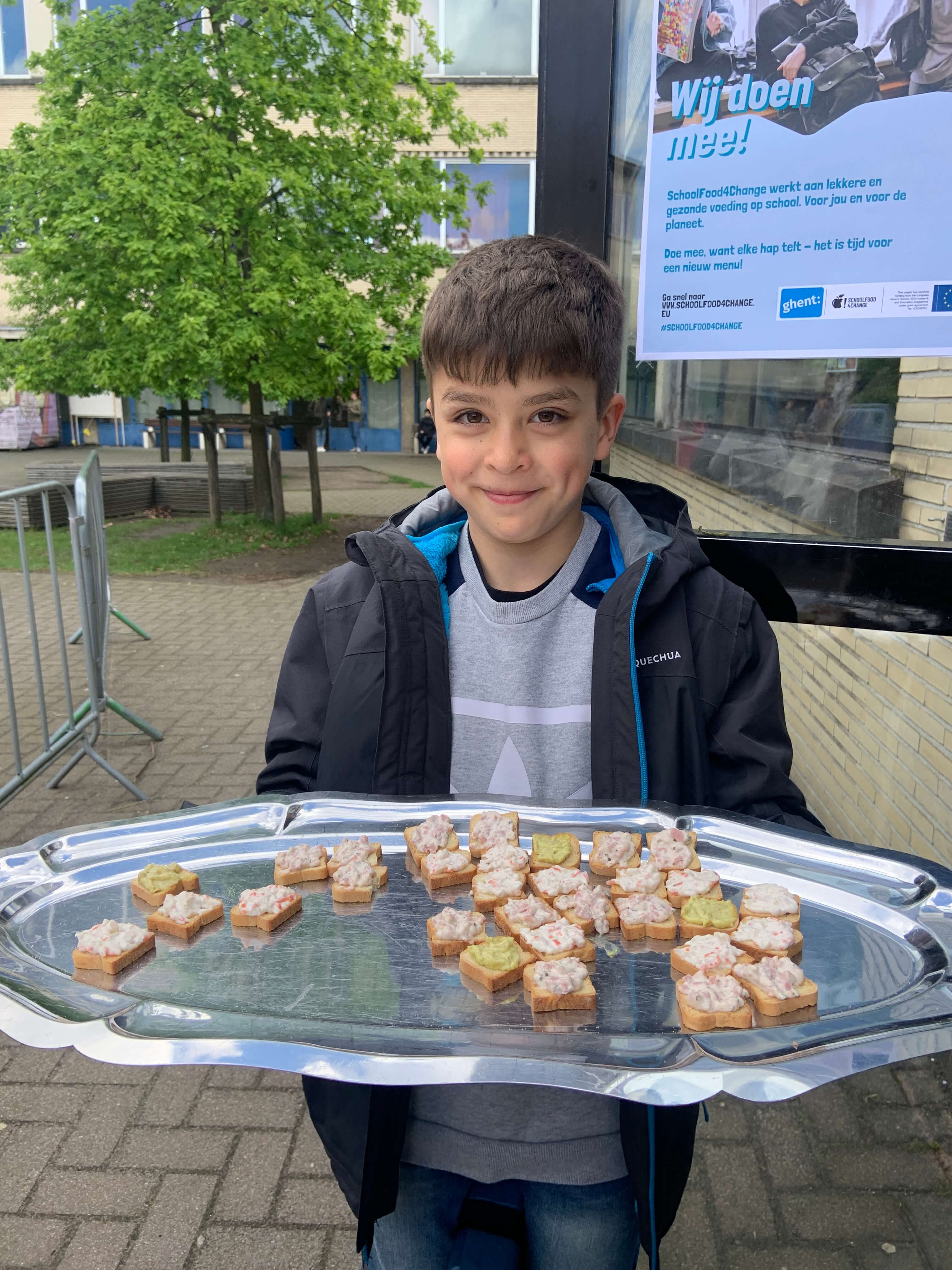 boy presenting left over toast samples on a tray