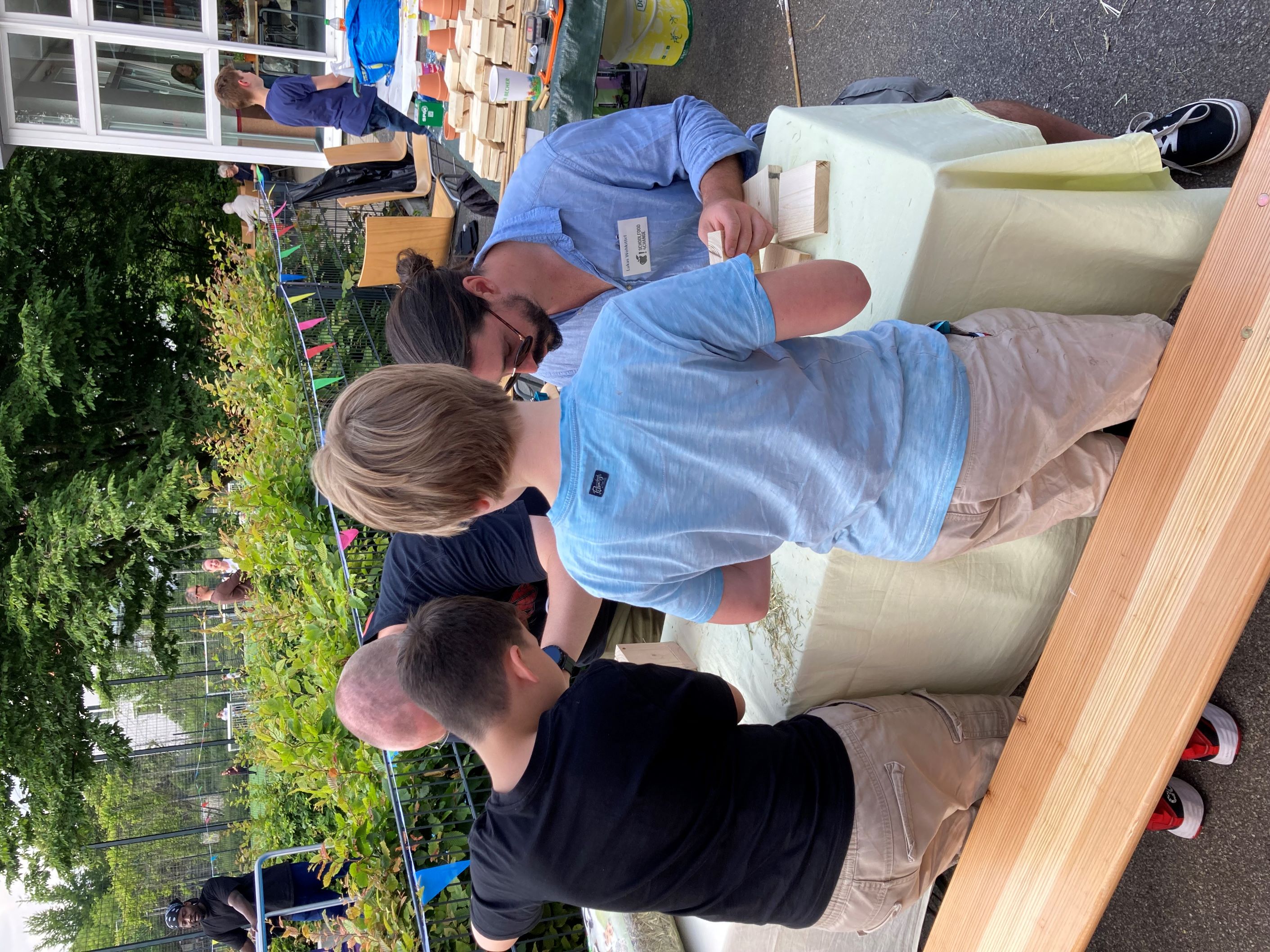 A small group of children and adults are playing while building ants houses.